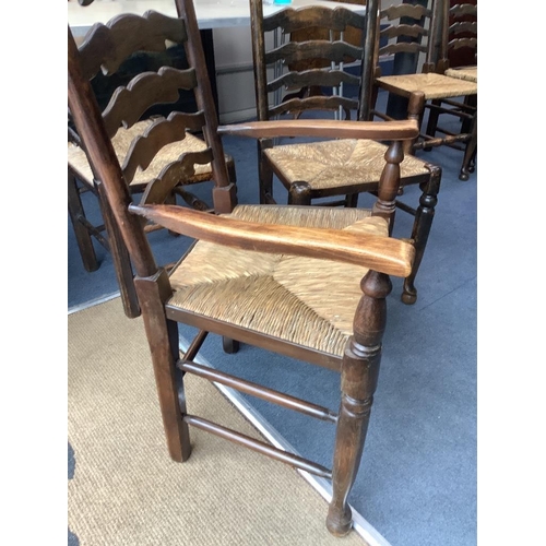 188 - A set of twelve ash rush seat ladder back dining chairs (two with arms)