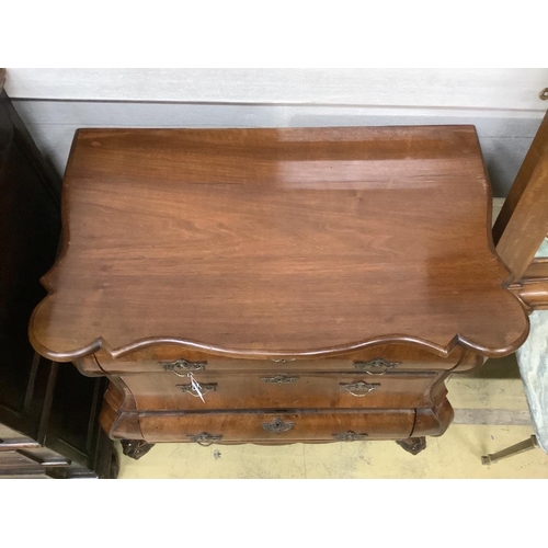 19 - A 19th century and later Dutch mahogany bombe chest of three long drawers, raised on claw and ball f... 