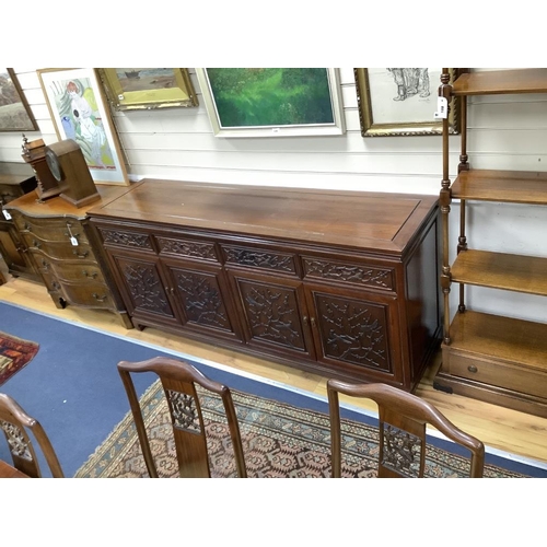 192 - A 20th century Chinese carved hardwood dining room suite comprising sideboard fitted with four drawe... 