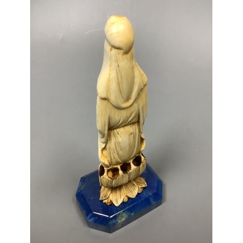 227 - A 19th century Chinese carved ivory Guanyin, on a later lapis lazuli base, height 14cm