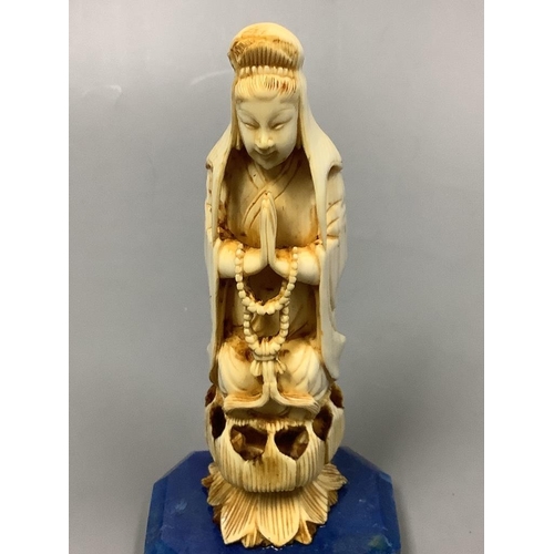 227 - A 19th century Chinese carved ivory Guanyin, on a later lapis lazuli base, height 14cm