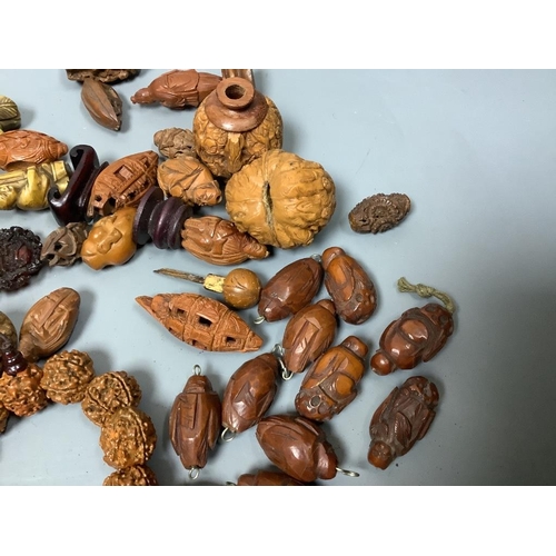 244 - An assortment of Chinese peach stone and a nut carvings