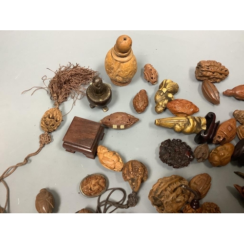 244 - An assortment of Chinese peach stone and a nut carvings