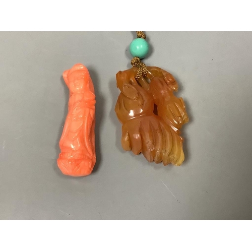 247 - A Chinese carved hardstone pendant, a carved coral Guanyin, an engraved nut pendant, and a lacquered... 