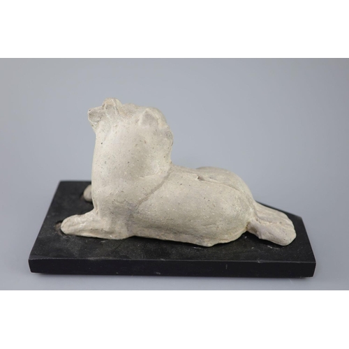 252 - A Chinese grey pottery figure of a recumbent dog, Han dynasty or later23.5cm long, wood stand... 