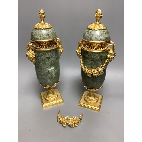 259 - A modern pair of gilt metal and marble urns32cm