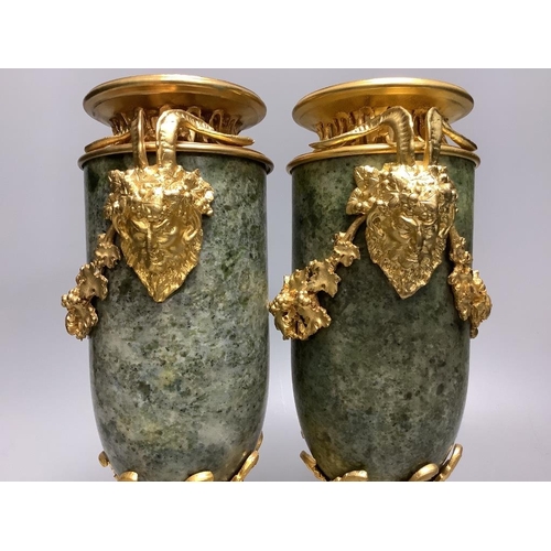 259 - A modern pair of gilt metal and marble urns32cm