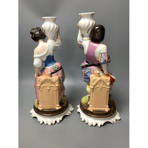 308 - A pair of Italian porcelain figures of soldiers and a pair of Continental figural candlesticks... 