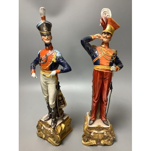 308 - A pair of Italian porcelain figures of soldiers and a pair of Continental figural candlesticks... 