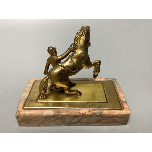 324 - An early 20th century gilt metal group of a horse and jockey, on marble base, length 13cm... 