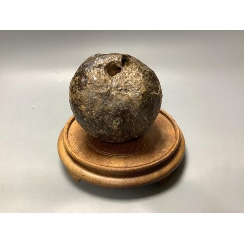 328 - A 17 / 18th century canon ball, on hardwood stand