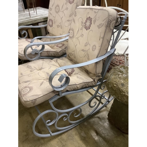 41 - A pair of painted wrought iron garden rocking armchairs with cushion seats, width 57cm, depth 86cm, ... 