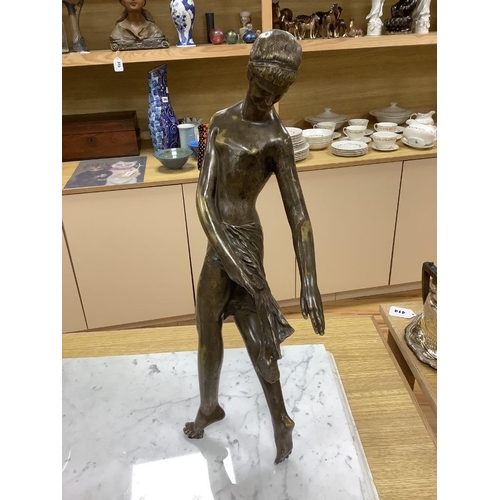 412 - An Art Deco style bronze lady and a marble sphere, on marble base, length 76cm