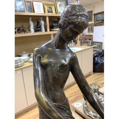 412 - An Art Deco style bronze lady and a marble sphere, on marble base, length 76cm