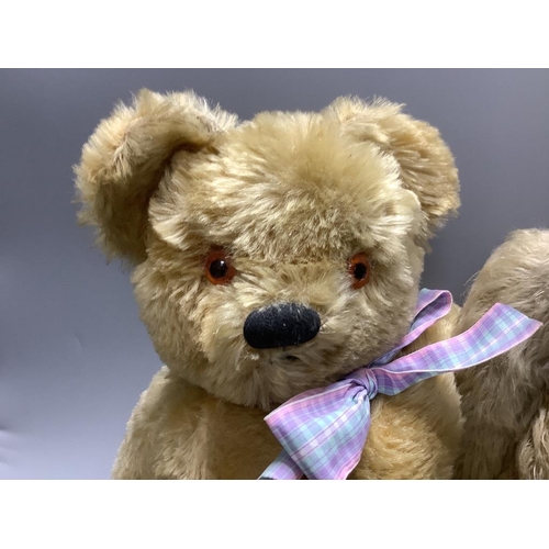 418 - A vintage large plush jointed teddy bear with glass eyes and long muzzle, a later smaller jointed be... 