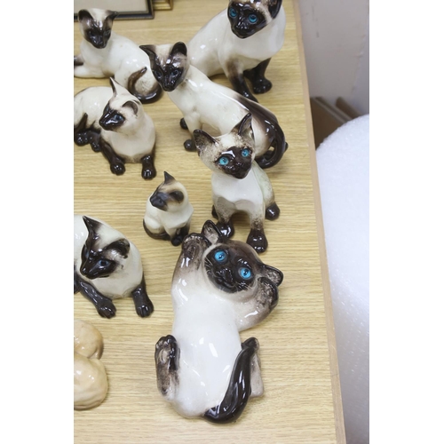 437 - Twelve Beswick cats including Siamese