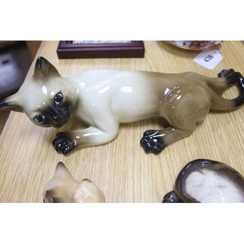 437 - Twelve Beswick cats including Siamese