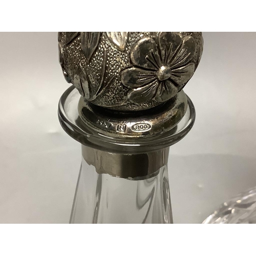 443 - A silver collared cut glass decanter and a glass scent bottle with 800 standard silver stopper, tall... 