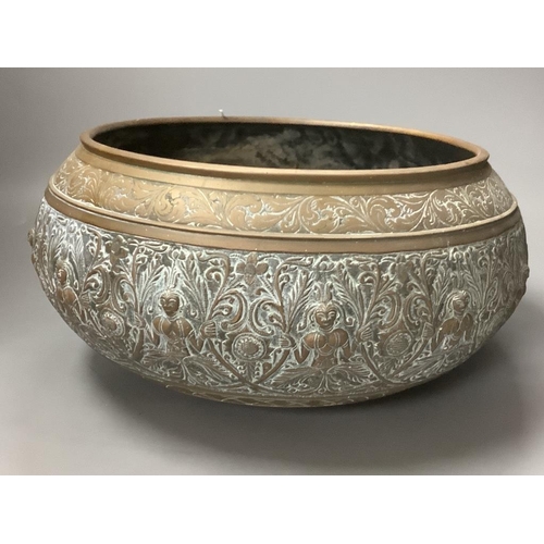 452 - A large Eastern brass bowl cast with bands of seated deities, foliate scrolls and linear decoration ... 