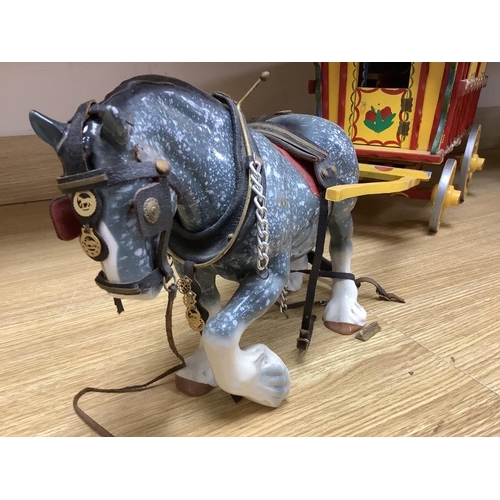 473 - A large painted wood model Gypsy caravan and ceramic horse, overall length 85cm