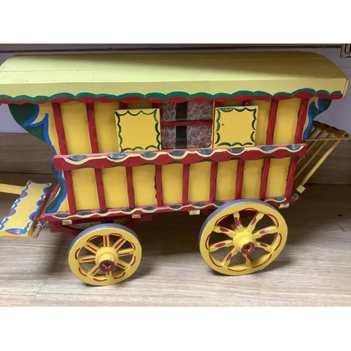 473 - A large painted wood model Gypsy caravan and ceramic horse, overall length 85cm