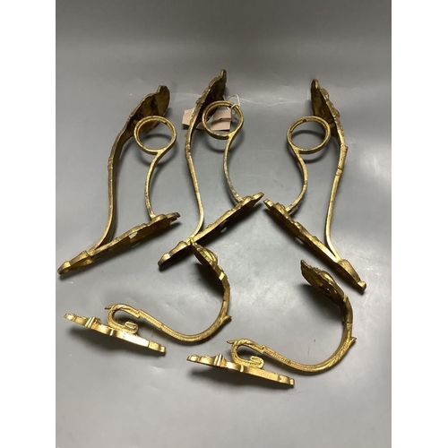 474 - A pair of French ornate gilt curtain tiebacks and a set of three similar curtain brackets... 