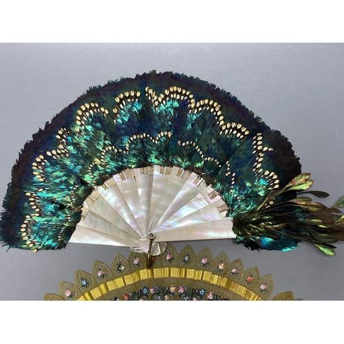 492 - An early 20th century peacock? feather and mother of pearl fan and an early 19th century French pain... 