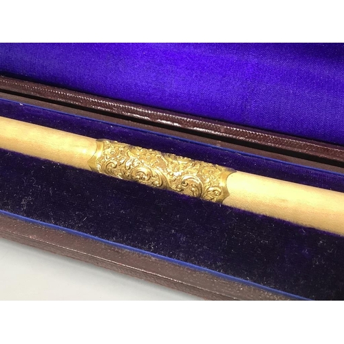 501 - A yellow metal mounted conductor's baton, with monogram to handle base, in fitted case