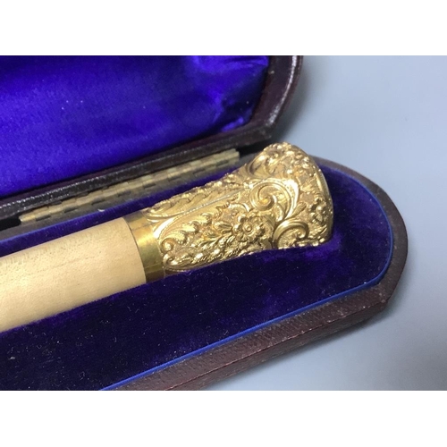 501 - A yellow metal mounted conductor's baton, with monogram to handle base, in fitted case