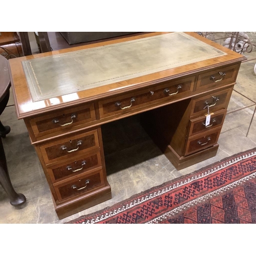 70 - A reproduction inlaid mahogany pedestal desk, width 122cm, depth 61cm, height 80cm together with a m... 