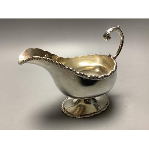 710 - A late Victorian demi fluted silver sugar bowl, Chester 1899, and an Edwardian silver pedestal sauce... 