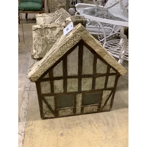 72 - A reconstituted stone garden ornament, modelled as a Tudor cottage, width 86cm, depth 50cm, height 5... 