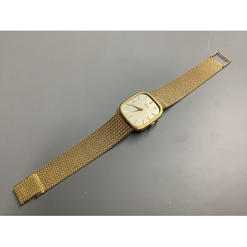 778 - A gentleman's modern 9ct gold Seiko quartz wrist watch on integral 9ct gold mesh link bracelet. over... 