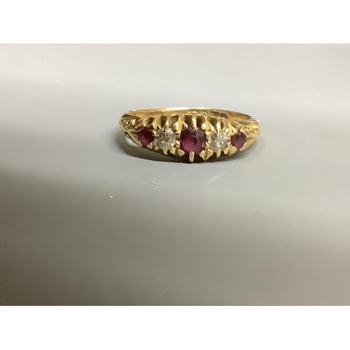 868 - An Edwardian 18ct gold, three stone ruby and two stone diamond set half hoop ring,size M, gross weig... 