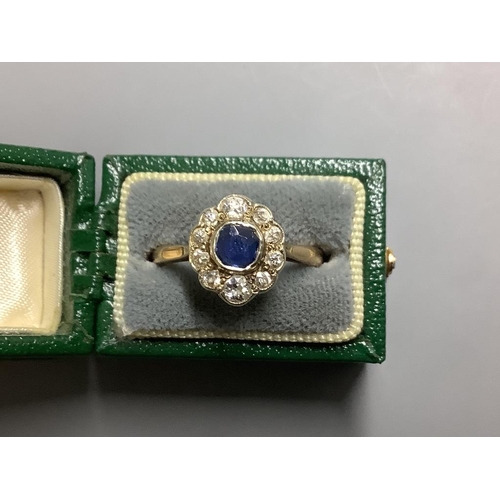 869 - An 18ct, sapphire and diamond set oval cluster ring,size M, gross 2.8 grams.