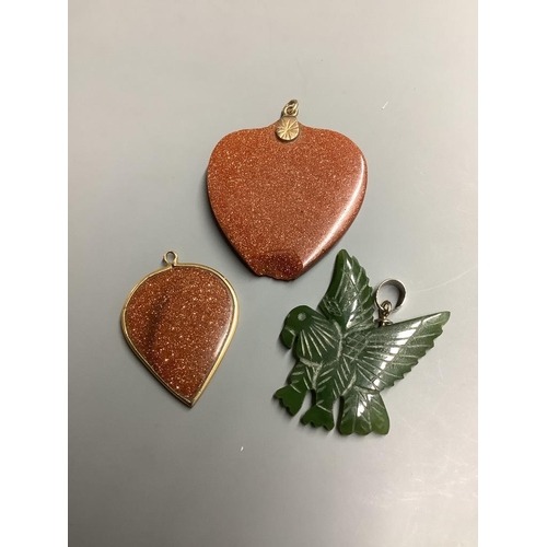 873 - Two adventurine glass pendants, one a.f. and one other carved hardstone pendant.