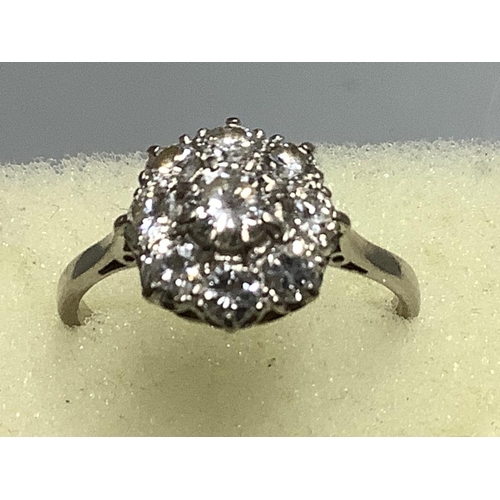 875 - A platinum and nine stone diamond circular cluster ring,size M, gross weight 2.9 grams.... 