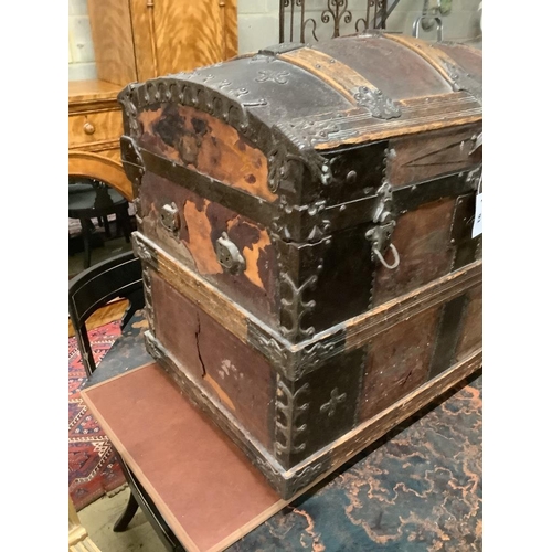 93 - A late Victorian leather and metal mounted dome top trunk with scrap-work interior, length 76cm, dep... 