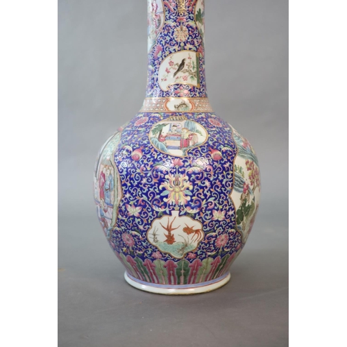 107 - A massive Chinese famille rose blue ground bottle vase, Daoguang period (1821-50),well painted to sh... 