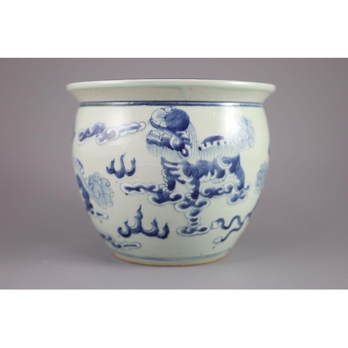 109 - A Chinese blue and white 'lion-dog' flower pot,painted with lion-dogs on white slip, on a pale celad... 