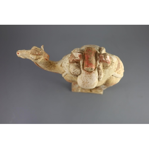 115 - A Chinese pottery model of a Bactrian camel and a similar head of a man, Tang Dynasty,the buff colou... 