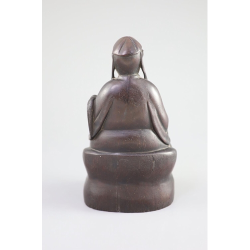 116 - A Chinese Zitan seated figure of an official, 18th century,the figure holding a fly whisk in his lef... 