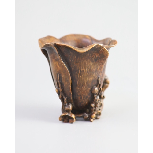 117 - A Chinese bamboo magnolia libation cup, 17th/18th century,carved as a magnolia flower, with gnarle... 