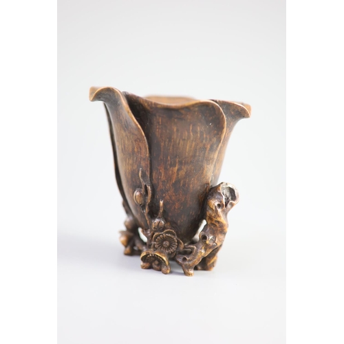 117 - A Chinese bamboo magnolia libation cup, 17th/18th century,carved as a magnolia flower, with gnarle... 