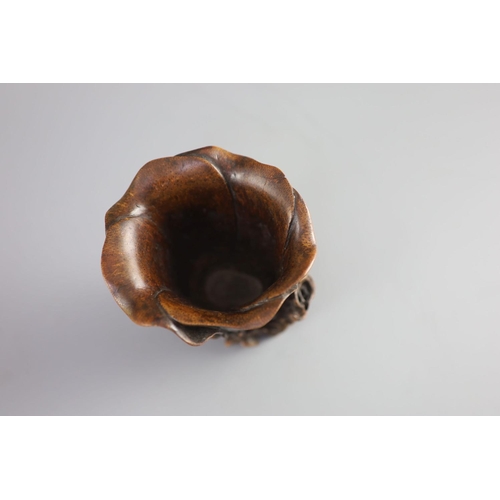 117 - A Chinese bamboo magnolia libation cup, 17th/18th century,carved as a magnolia flower, with gnarle... 