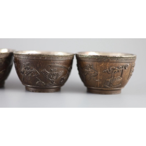 119 - A set of six Chinese coconut cups, 18th/19th century,each carved in relief with figures amid pavilio... 