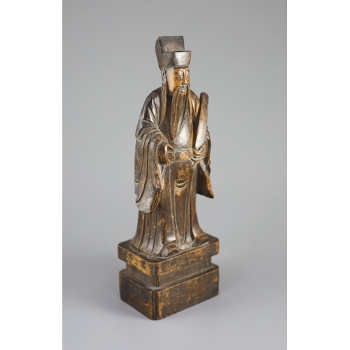 123 - A Chinese boxwood figure of an immortal, 19th century,the figure holding a tablet in his left hand a... 