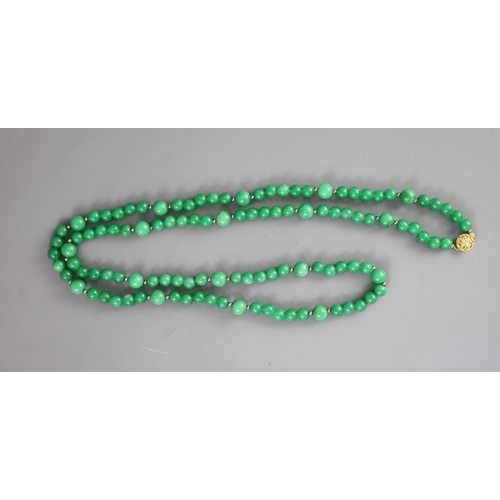 134 - A Chinese green jadeite bead necklace,gilt metal clasp strung with 7mm beads interspersed by 10mm be... 