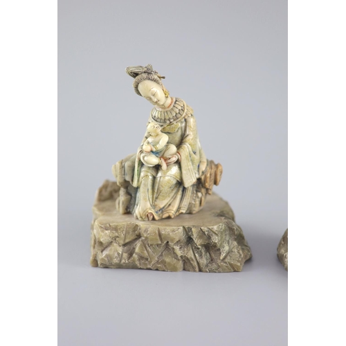 136 - A Chinese soapstone group of Guanyin and child, probably Kangxi period,with remants of polychrome de... 