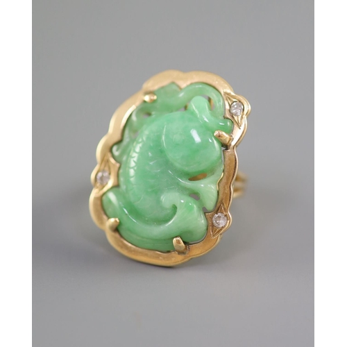 139 - Two Chinese jadeite and gilt metal clips, first half 20th century and a yellow metal jadeite fish ... 